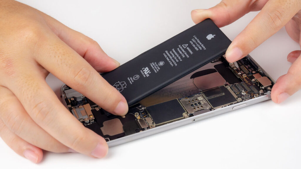 Man disassembling a modern phone to show the type of battery inside.