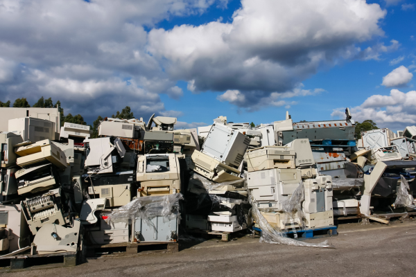 A polluted landfill filled with discarded electronics illustrating improper e-waste disposal.